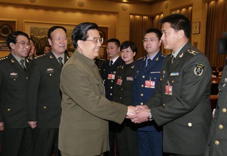 Chinese President Hu Jintao (front L), who is also chairman of the Central Military Commission, shakes hands with a deputy of the Chinese People's Liberation Army (PLA) to the Second Session of the 11th National People's Congress (NPC), in Beijing, capital of China, March 11, 2009. Hu Jintao attended the plenary meeting of the PLA delegation on Wednesday. (Xinhua/Wang Jianmin)