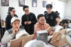 Xiao Jin (center) and American teacher Nicole Chilelli assess trainees' work.jpg