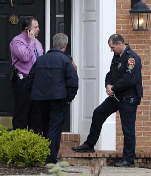 Fairfax County Police stand on the front step of the home of David Kellermann, acting chief financial officer of mortgage giant Freddie Mac, in Vienna, Virginia, April 22, 2009. Kellermann, acting chief financial officer of troubled U.S. mortgage giant Freddie Mac, was found dead on Wednesday in his suburban Virginia home after apparently committing suicide, a local police source said.
